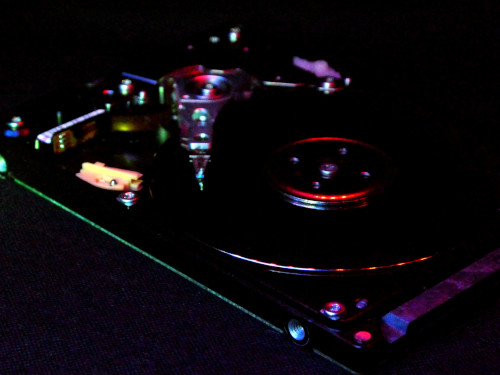 A hard disk drive opened up to show the platters and heads